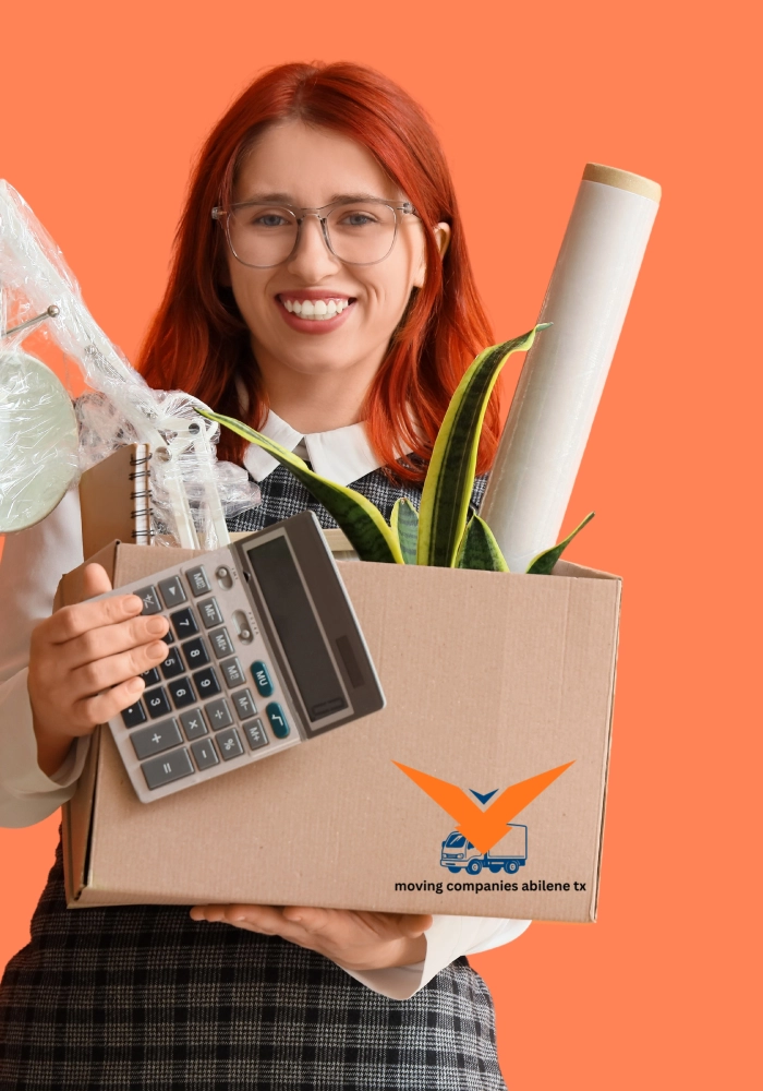 A smiling professional mover in an orange jumpsuit carrying a box, representing reliable and affordable moving companies in Abilene TX.
